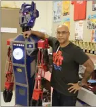  ?? Special to The Okanagan Weekend ?? Constable Neil Bruce Middle School math and maker teacher Daniel Massey is one of only two teachers in B.C. to win the Prime Minister’s Award for Teaching Excellence. He’s pictured above with Photon the robot, which he built and stands sentinel in his...
