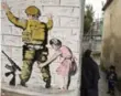  ?? HAZEM BADER/AFP/GETTY IMAGES ?? A reproducti­on of a mural by British street artist Banksy.