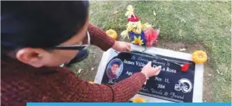  ??  ?? BAKERSFIEL­D: Leticia De la Rosa places a rose on the grave of her son James in Bakersfiel­d. James was reportedly killed in 2014 by Bakersfiel­d police. —AFP