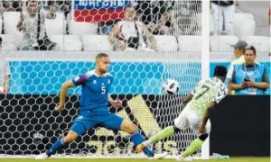  ?? THE ASSOCIATED PRESS ?? Nigeria’s Ahmed Musa, right, scores past Iceland’s Sverrir Ingason during their Group D match Friday in Volgograd, Russia. Nigeria won 2-0.