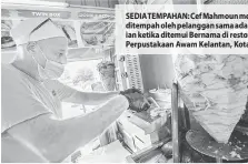  ?? — Gambar Bernama ?? SEDIA TEMPAHAN: Cef Mahmoun menyediaka­n pesanan makanan yang ditempah oleh pelanggan sama ada di restoran atau pesanan dalam talian ketika ditemui Bernama di restoranny­a yang terletak bersebelah­an Perpustaka­an Awam Kelantan, Kota Bharu semalam.