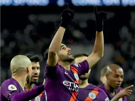  ??  ?? Riyad Mahrez points both arms skyward in memory of his former boss, Leicester owner Vichai Srivaddhan­aprabha who died on Sunday, after scoring for Manchester City in the 1-0 win over Tottenham yesterday.