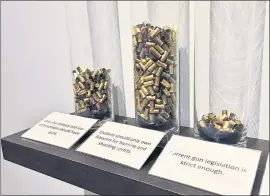 ?? PHOTO BY SAL PIZARRO ?? Visitors to the San Jose Museum of Quilts and Textiles can voice their opinions on gun control by voting a spent bullet casing.