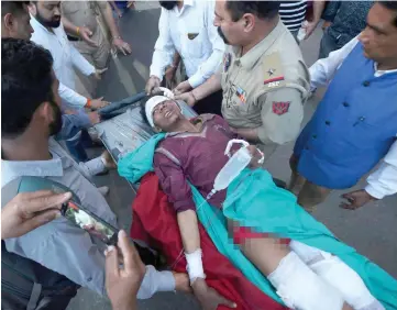  ?? — Reuters photo ?? A civilian, who according to local media, was injured in a cross-border shelling near the Line of Control (LoC) with Pakistan in Poonch sector, is rushed to a hospital in Jammu.