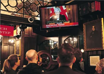  ?? DAN KITWOOD/GETTY IMAGES ?? British Prime Minister Theresa May delivers her speech on television at a pub Thursday in London. The pound experience­d aggressive selling on Thursday as questions swirled about May’s leadership after several ministers resigned over her draft agreement for Brexit.