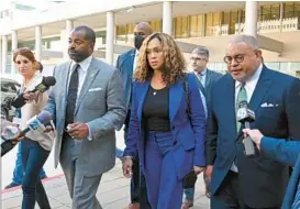  ?? LLOYD FOX/BALTIMORE SUN ?? Former Baltimore State’s Attorney Marilyn Mosby leaves federal court with her husband, Nick Mosby, and lawyer, A. Scott Bolden, in September.