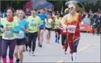  ?? PHOTOS BY GAO ERQIANG / CHINA DAILY ?? Organized by State-owned enterprise ELEM, the Shanghai Marathon is the only "golden label" road race in China that still offers the 5km, 10km and half marathon events.