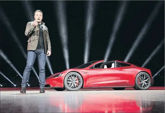  ?? HANDOUT / REUTERS ?? El fundador y consejero delegado de Tesla, Elon Musk, junto al deportivo Roadster