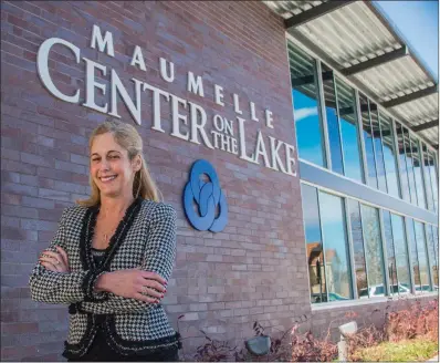  ?? WILLIAM HARVEY/RIVER VALLEY & OZARK EDITION ?? Nicole Vogler, director of senior services in Maumelle, stands in front of Center on the Lake, which opened in March 2016. The senior center was designed to be expanded, and Vogler’s dream is to add an aquatic center. She was honored as Person of the...