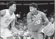  ?? NWA Democrat-Gazette/CHARLIE KAIJO ?? Arkansas forward Darious Hall looks to drive to the basket against Tennessee guard Jordan Bowden (23) during the Razorbacks’ 84-66 loss to the No. 13 Volunteers on Saturday in the semifinals of the SEC Tournament in St. Louis. Hall finished with 11...