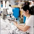  ?? GETTY-AFP ?? A woman works on socks that will be exported at a factory in Huaibei in China’s eastern Anhui province last month.