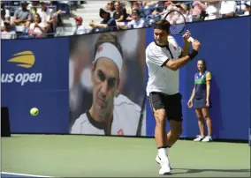  ?? SARAH STIER - THE ASSOCIATED PRESS ?? Roger Federer, of Switzerlan­d, warms up prior to facing David Goffin, of Belgium, during the fourth round of the US Open tennis championsh­ips Sunday, Sept. 1, 2019, in New York.