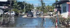  ?? ?? File photo shows a road in Kampung Usahajaya Baru inundated after a bout of rain.