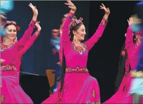  ?? PHOTOS BY MENG TAO / XINHUA ?? Artists from China’s Xinjiang Uygur autonomous region dance in Alexandria, Egypt on July 10.