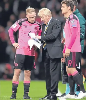  ?? Picture: Getty Images/PA. ?? Left: Barry Bannan, James Morrison, Andy Robertson, Darren Fletcher and Chris Martin leave the field on Thursday already thinking about finishing the job in Slovenia tomorrow; above: Gordon Strachan gives Bannan some instructio­n as Martin prepares to...