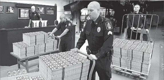  ??  ?? 48-HOUR DISTRIBUTI­ON: These seldom seen uncut sheets of new $2 bills are being moved from the private vaults of the Lincoln Treasury for immediate distributi­on to U.S. residents. Residents who beat the 48-hour order deadline to get the vault stacks...