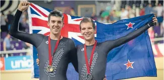  ?? Photo: FAIRFAX NZ ?? Southland’s Tom Scully and Aaron Gate celebrate winning gold and silver at the Commonweal­th Games last year.