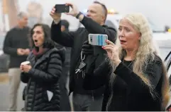  ?? Santiago Mejia / The Chronicle ?? Melissa McConnell watches her old house get torn down. “It’s hard to give up the dream,” she says, “but what can you do?”