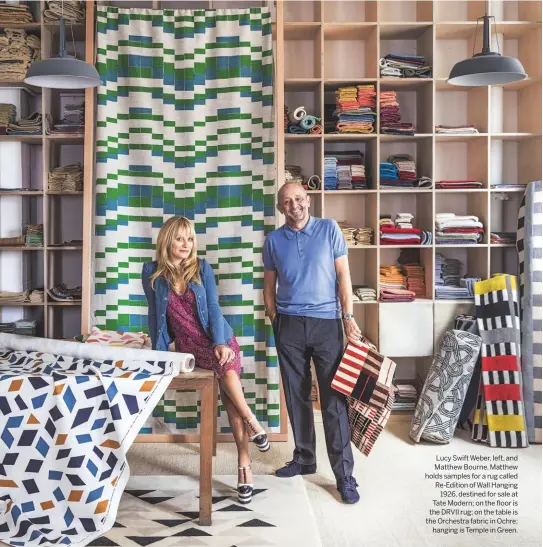  ??  ?? Lucy Swift Weber, left, and Matthew Bourne. Matthew holds samples for a rug called Re-edition of Wall Hanging 1926, destined for sale at Tate Modern; on the floor is the DRVII rug; on the table is the Orchestra fabric in Ochre; hanging is Temple in Green.