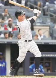  ?? Julio Cortez / Associated Press ?? The Yankees’ Clint Frazier hits a solo home run off the Royals’ Heath Fillmyer on April 20 in New York.