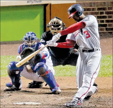  ?? AP/CHARLES REX ARBOGAST ?? Michael Taylor of the Washington Nationals connects on a grand slam Wednesday in the eighth inning of the Nationals’ 5-0 victory over the Chicago Cubs in Game 4 of the National League division series. The Nationals host Game 5 tonight.