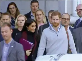  ?? AUSTRALIAN POOL VIA AP ?? Britain’s Prince Harry, center right, and his wife Meghan, center left, Duke and Duchess of Sussex, approach a car at an airport in Sydney, Monday, Oct. 15, 2018. Prince Harry and his wife Meghan arrived in Sydney on Monday, a day before they officially start a 16-day tour of Australia and the South Pacific.