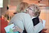 ?? JOHN BAZEMORE/AP ?? Ebola survivor Nancy Writebol (right) embraces Linda McCauley, dean of Emory University’s nursing school.