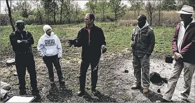  ?? | PHOTO PROVIDED ?? Volunteer Kevin Kuhn (center) describes safe practices for burning brush piles during a 2012 Calumet Volunteer Leadership Training Workshop.