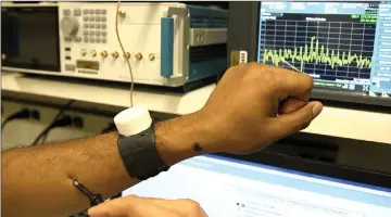  ??  ?? Through a prototype watch, a person can receive a signal from anywhere on the body, from the ears all the way down to the toes. — Purdue University photo by Debayan Das
