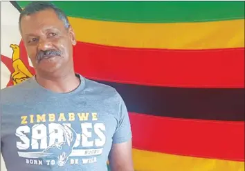  ??  ?? PROUDLY ZIMBABWEAN . . . New Sables coach Peter de Villiers stands against the background of the Zimbabwe flag after addressing a media conference in Johannesbu­rg, South Africa, yesterday