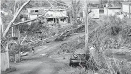  ?? GERALD HERBERT/AP 2017 ?? Damage can be seen in Yabucoa, Puerto Rico, in the days after Hurricane Maria struck in September 2017. The U.S. said Friday it is sending nearly $13 billion to the island territory.