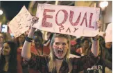  ?? JOE RAEDLE, GETTY IMAGES ?? Clarissa Horsfall joins the A Day Without A Woman rally March 8 in Miami to draw attention to pay disparitie­s that data show have women earning as little as 80 cents for every dollar earned by men.
