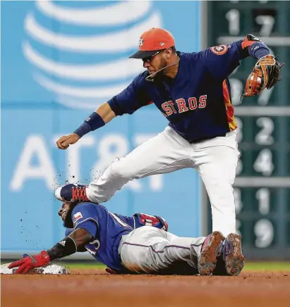  ?? Karen Warren / Staff photograph­er ?? In a chance cleating at second base, the Rangers’ Jurickson Profar takes a shoe to the face from the Astros’ Yuli Gurriel, who had left the bag uncovered and stumbled trying to get to it as Profar stretched a sixth-inning RBI hit into a double.