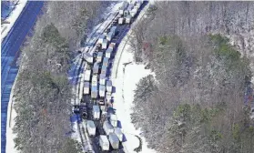  ?? ?? Drivers wait for the traffic to be cleared as cars and trucks are stranded on sections of Interstate 95 on Jan. 4 in Carmel Church, Va. STEVE HELBER/AP FILE