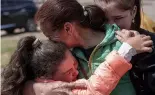  ?? ?? Khrystyna Pyimak, 11, hugs her mother Oksana Velychko, 42, a er evacuation from Vovchansk, 12 May 2024