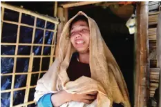  ??  ?? Myanmar Rohingya migrant Nur Begum reacts after the death of her six-month-old son Alam in a refugee camp in Teknaf, in Bangladesh’s Cox’s Bazar district, yesterday. — AFP