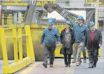  ?? CATHIE COWARD THE HAMILTON SPECTATOR ?? Premier Kathleen Wynne and MPP Ted McMeekin are given a tour of the zinc line at Stelco Wednesday afternoon.