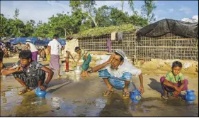  ?? AP PHOTO ?? Rohingya Muslims, who crossed over from Myanmar into Bangladesh, perform ablution before offering afternoon prayers at Balukhali refugee camp, Bangladesh yesterday.