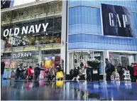  ?? DREW ANGERER / GETTY IMAGES ?? Old Navy and Gap stores in Times Square on Friday. Gap Inc. has announced plans to separate into two publicly traded companies, spinning off Old Navy.