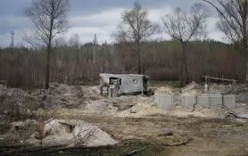  ?? Efrem Lukatsky, The Associated Press ?? Russian trenches and firing positions in the highly radioactiv­e Red Forest stuffed with radioactiv­e remnants near the Chernobyl nuclear power plant on Saturday.