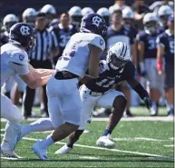  ?? Icon Sportswire via Getty Images ?? Yale Bulldogs defensive back Dathan Hickey (11) reads the play and makes a quick tackle on Holy Cross Crusaders running back Jordan Fuller (23) during the game on Sept. 18 at the Yale Bowl in New Haven.