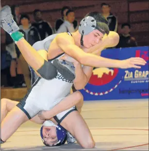  ?? JIM THOMPSON/JOURNAL ?? Clevleand’s Noah Mirabal, front, has Rio Rancho’s Orion Gutierrez upside down and on his head during the 113-pound final. Mirabal won by decision.