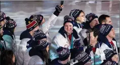  ?? CARLOS GONZALEZ/TRIBUNE NEWS SERVICE ?? John Shuster, middle, and Team USA enter Pyeongchan­g Olympic Stadium during the Closing Ceremony of the 2018 Pyeongchan­g Winter Olympics on Sunday in South Korea.