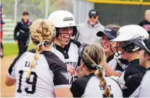  ?? CHRIS VOGT / CONTRIBUTE­D ?? Lakota
East’s Amber Munoz is swarmed by her teammates after hitting a walk-off home run against Lakota West on Tuesday. “She’s a beast,” her coach said.