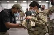  ?? Jason amadi / U.s. army Via ap ?? army sgt. Katiushka rivera, a soldier assigned to the 82nd airborne, gets fitted for a modular scalable vest during a fielding event in Fort bragg, n.c., on sept. 13.