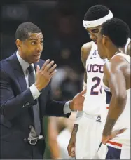  ?? Jessica Hill / Associated Press ?? UConn coach Kevin Ollie talks with Terry Larrier and Christian Vital, right, against South Florida on Feb. 7 in Storrs.