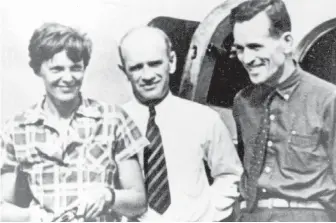  ??  ?? In this file photo taken around July 2, 1937, Amelia Earhart, left, and her navigator, Fred Noonan, right, pose beside their plane with gold miner F.C. Jacobs in Lae, New Guinea, just before Earhart and Noonan took off on a flight to Howland Island,...