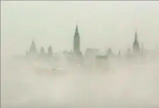  ?? FRED CHARTRAND, THE CANADIAN PRESS ?? Parliament Hill is shrouded with early morning ice fog from the Ottawa River Friday.