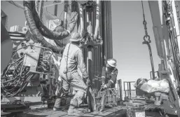  ?? TAMIR KALIFA/THE NEW YORK TIMES 2019 ?? Floorhands work on a rig contracted to Shell near Wink, Texas. Royal Dutch Shell has sold its oil and gas production in the Permian Basin.