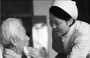  ?? PROVIDED TO CHINA DAILY ?? A nurse takes care of an elderly patient at a Kangning Hospital in Ningbo, Zhejiang province. The hospital belongs to the largest private psychiatri­c healthcare group in China.